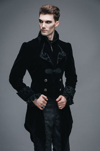Side view of man wearing black Gothic velvet tailcoat with brocade cuffs and silver buttons