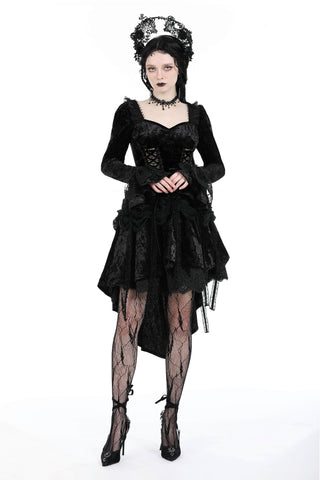 Woman standing in a black Gothic lace dress with sweetheart neckline, corset bodice, layered skirt, lace crown, and patterned tights – against a white background.