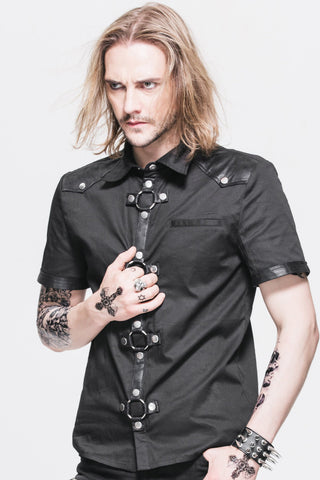 Man wearing a black short-sleeve shirt with faux leather trim and metal O-ring details, posing against a white background.