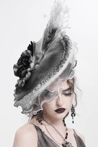 Woman wearing eva kady eas02401 a Gothic Victorian hat with black roses, lace veil, and feather trim on a white background.