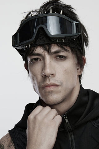 Male model wearing punk rave ws-876 black cyberpunk goggles with silver spikes and tinted lenses, styled over a black headwrap and sleeveless vest.