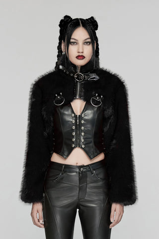 Model wearing black cropped faux fur bolero jacket with PVC strap details, over leather corset and pants, on a grey background