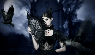 Gothic woman in black lace dress with fan and ravens under moonlight