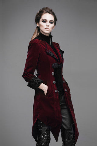 Red velvet swallowtail jacket with black accents, worn by female model – front view.