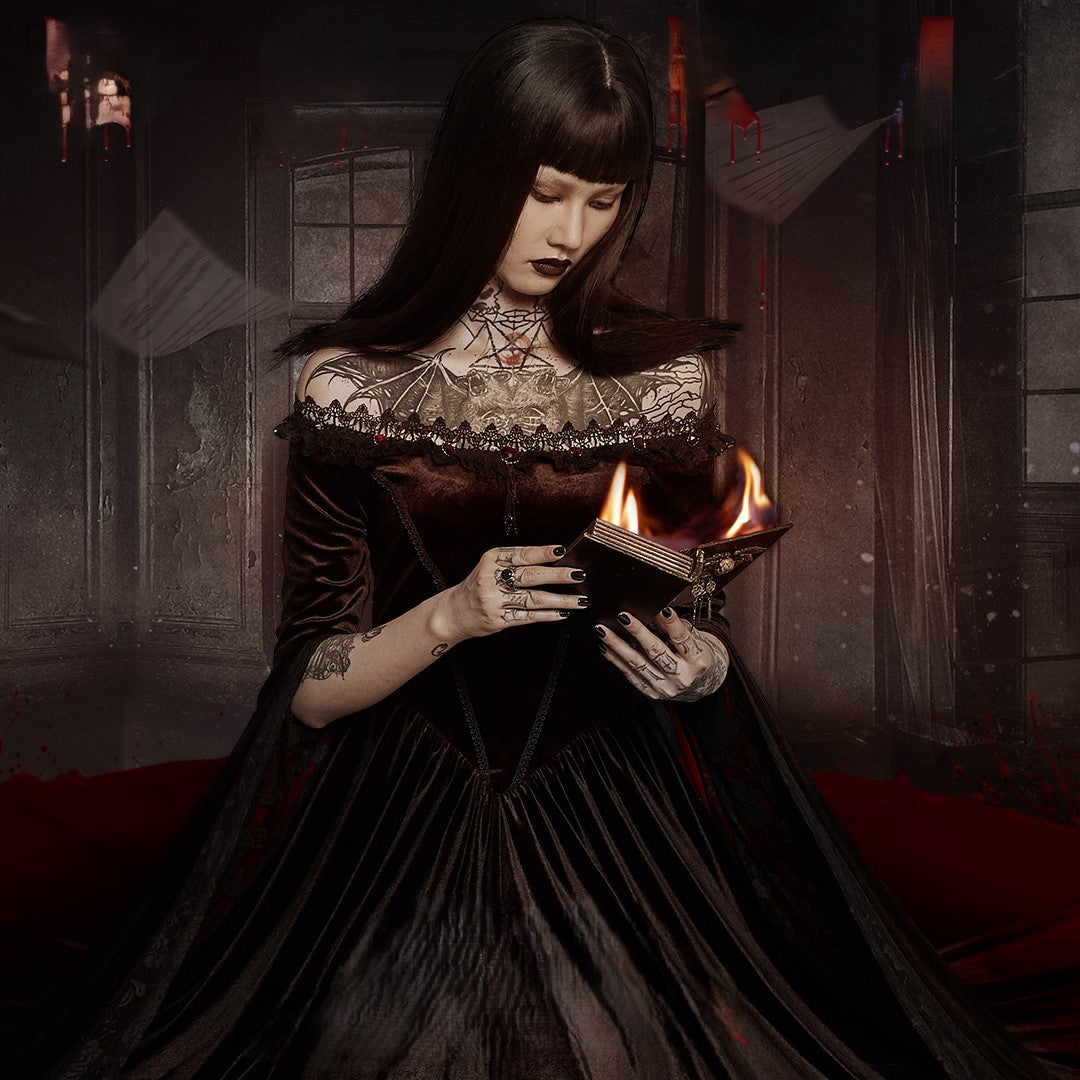 Woman dressed as a Gothic necromancer holding a burning book in a dark Victorian setting, fantasy cosplay look