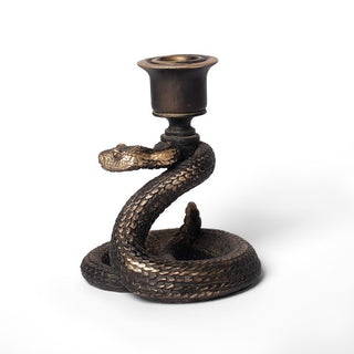 Rear view of an antique gold snake-shaped resin candlestick holder on a white background
