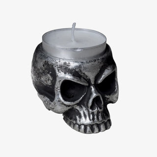 Antique silver skull tea light holder with a white tea light candle on a white background