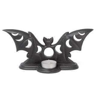 Rear view of a black bat moon phase tea light holder with a tea light candle