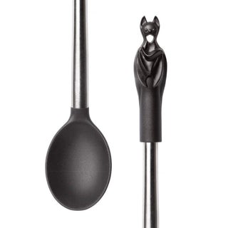Close-up of a black kitchen spoon with a sculpted bat handle and stainless steel shaft