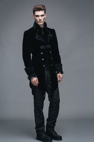 Full-body front view of man wearing black Gothic velvet tailcoat with brocade cuffs and pointed hem
