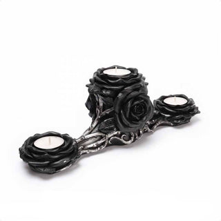 Angled view of a black rose triple tea light holder with three candles and antique silver vine details