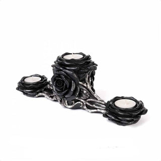 Side angle view of a black rose triple tea light holder with three white candles and silver vine details