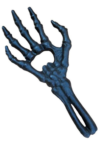 Cast iron skeleton hand bottle opener on a white background