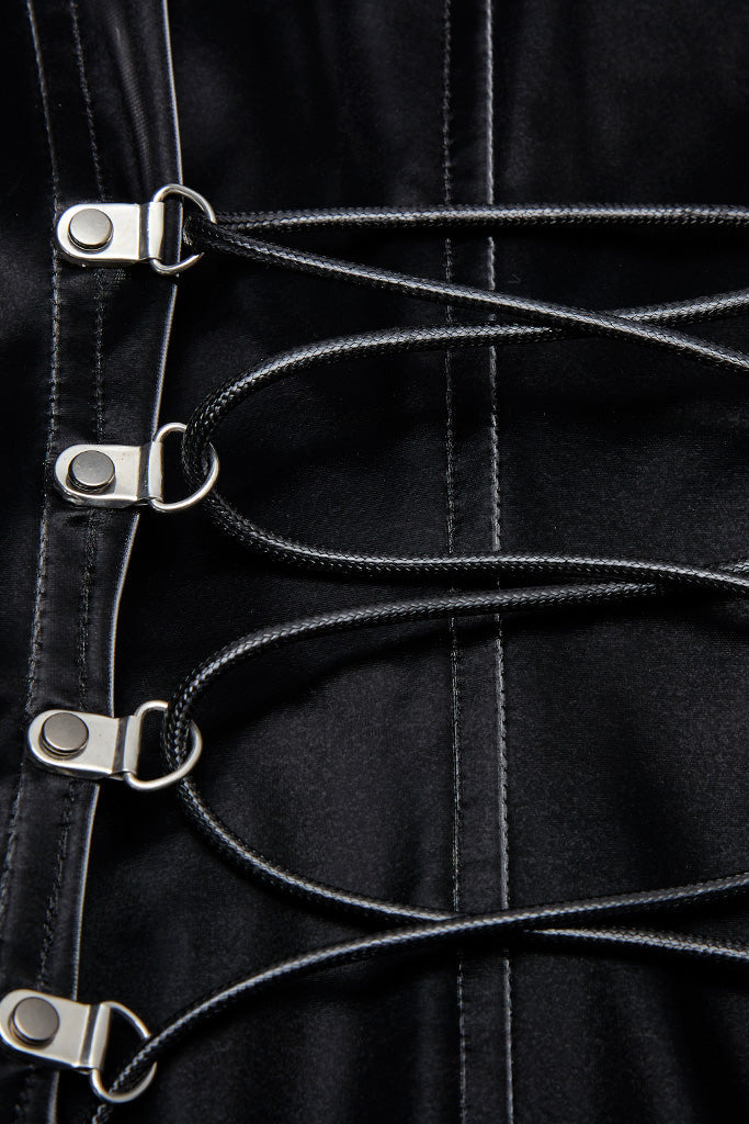 Close-up of black satin lace-up back with silver loops on cyberpunk mini dress