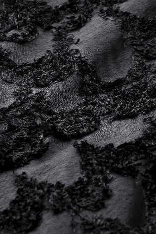 Detailed view of burnout lace and velvet texture in black gothic skirt