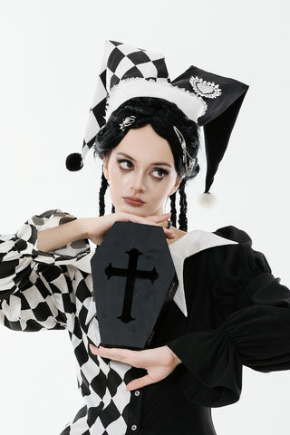 Black and white harlequin jester hat with diamond pattern and pom-pom tips