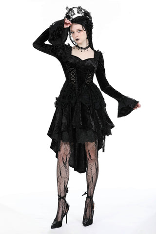 Model wearing a black Gothic dress with flared long sleeves, sweetheart neckline, layered asymmetrical lace skirt, and lace crown headpiece – posing against a white background.