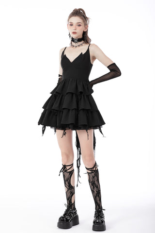 Woman wearing a black Romantic Gothic ruffle dress with a pointed neckline, tiered skirt, and lace-up back, paired with black lace knee-high socks and platform boots on a white background.