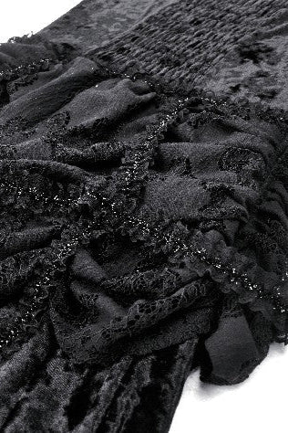 Detail of beaded lace trim and gathered velvet fabric in black.