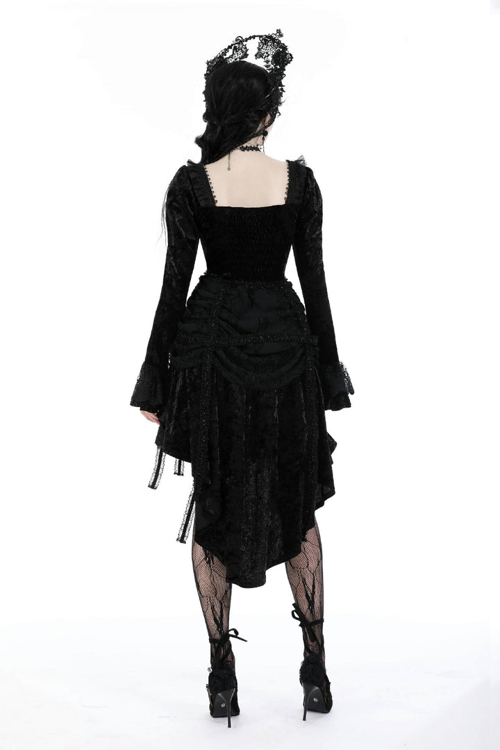 Model showing back of Gothic black dress with long lace sleeves, ruffled skirt, and square neckline on a white background.