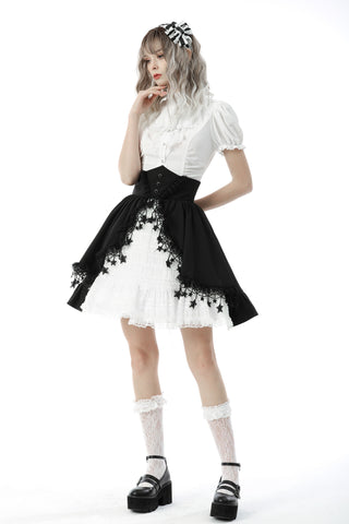 Model posing in a white puff-sleeve Victorian blouse with high collar, black corset-style belt, and white lace skirt with black lace overlay – hands near face and hip, on white background.