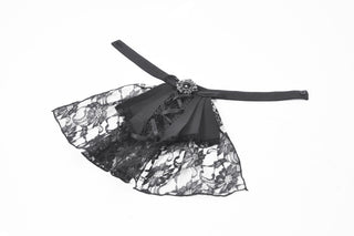 Detachable black lace jabot with ribbon ties and ornate brooch, laid flat on a white background