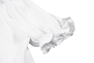 Close-up of white puff sleeve with gathered ruffled cuff, laid flat on a white background