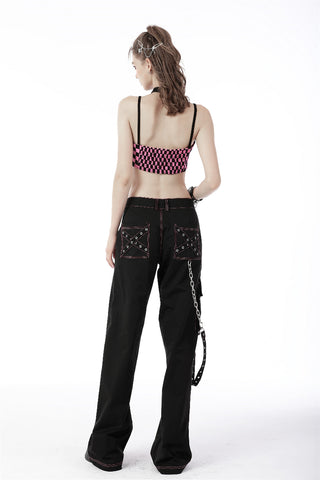 Back view of model wearing black Y2K punk trousers with pink stitching, chain strap, and studded back pockets, styled with a pink checkered crop top on white background