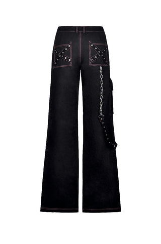 Flat lay of black Y2K punk trousers with pink contrast stitching, criss-cross grommet pocket design, and side chain strap on white background