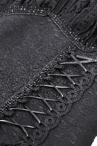 Close-up of corset back detail on black Gothic gown, showing lace-up grommets and textured fabric
