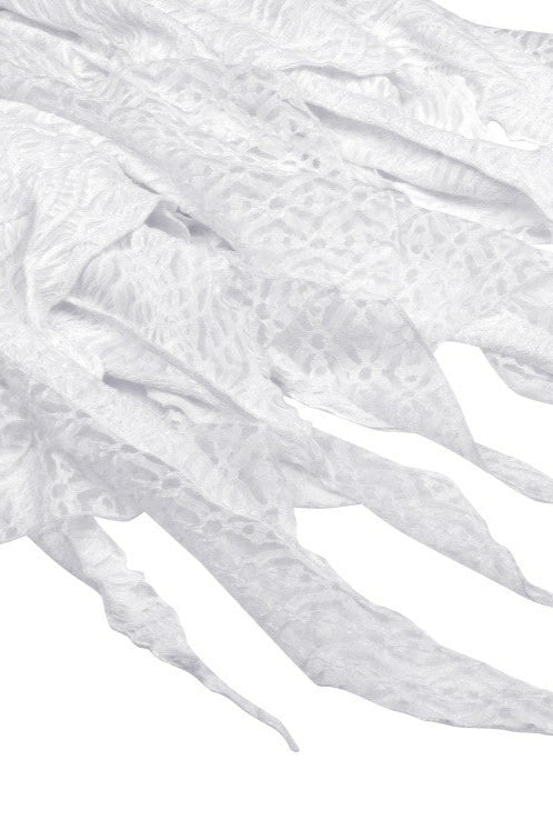 Close-up of handkerchief hem and layered lace on white Gothic dress