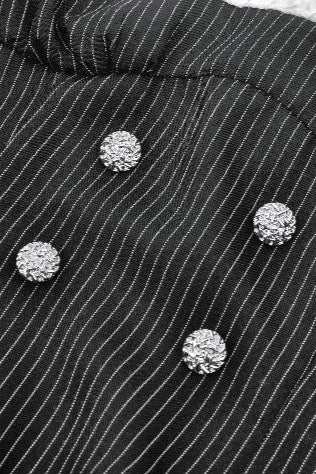 Decorative button details on front of pinstriped bodice