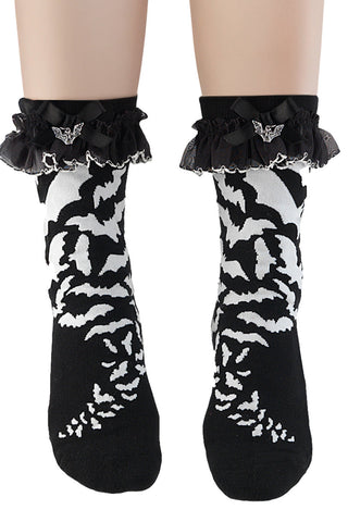 Black and white bat-patterned socks with a ruffled lace top, shown on a white background.