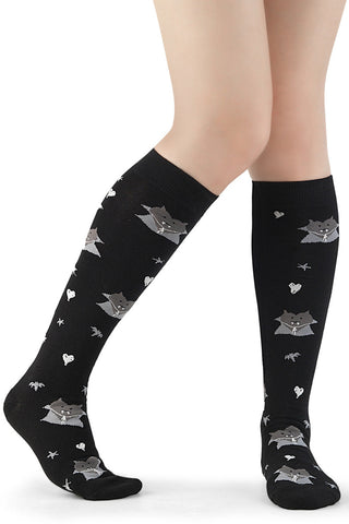 Black knee-high socks with woven vampire face motifs and small spooky icons.