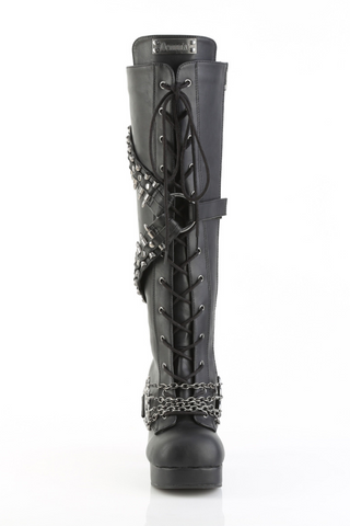 Demonia Gothika-108 black knee-high platform boot, front view with lace-up closure, bullet-spike straps wrapping the shaft, and heavy chains with a brass-knuckle buckle across the foot