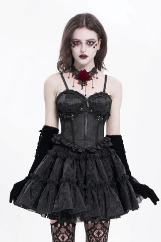 Model wearing a Devil Fashion black brocade corset top with a sweetheart neckline, floral lace, front zip and ruffled hem.