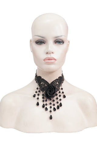 Mannequin wearing a black lace choker with satin rose and beaded fringe against a white background.