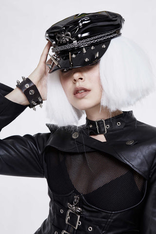Black patent studded chain cap with spikes worn with leather outfit, front angle
