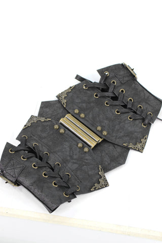 Angled flat lay of Devil Fashion AS045 Steampunk waist cincher showing bronze front clasp, black faux leather texture, and corner scroll detailing.