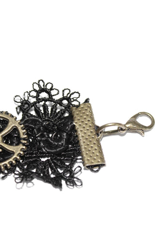 Close-up of Devil Fashion AS057 bracelet clasp showing black lace edge, antique brass gear, and lobster claw closure with textured metal connector.