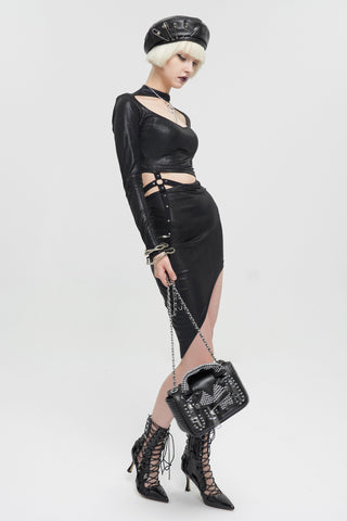 Full body model wearing a black alternative outfit with a studded punk rock biker jacket handbag and chain strap.