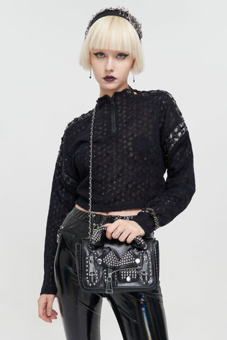 Model holding a studded punk rock biker jacket handbag with silver hardware and oversized zip details.