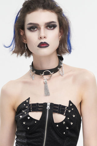Model wearing black O-ring choker with side chains and hanging chain tassel