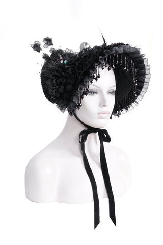 Devil Fashion AS195 black Victorian-style bonnet with lace frills, bead fringe, fabric roses, and satin ribbon tie, displayed on a mannequin head against a white background.