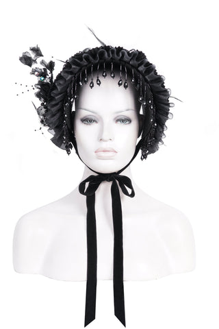Black Victorian-style bonnet headband with lace ruffles, bead fringe, fabric flowers, and satin ribbon, displayed on a white mannequin bust against a white background.