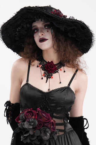 Model wearing the Night at the Opera black Gothic wide-brim hat with lace, red flowers and feathers.
