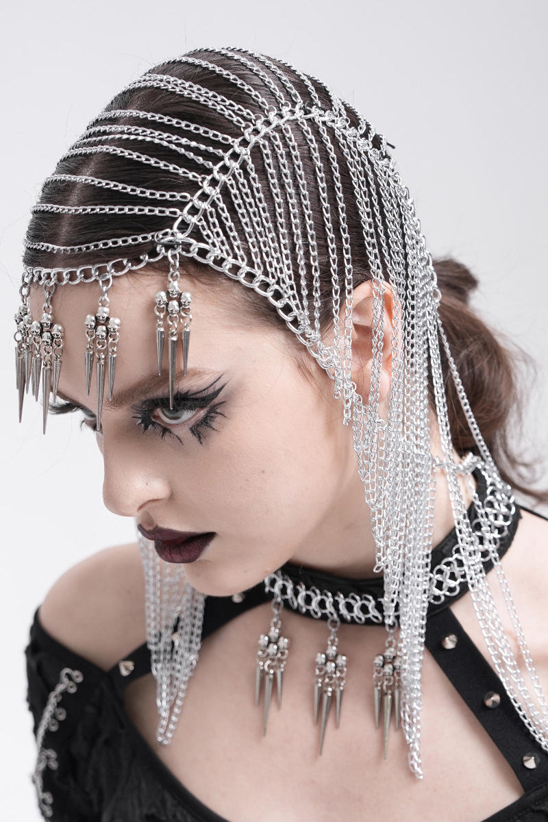 Gothic model wearing silver chain headpiece with skull spike pendants and matching choker harness.