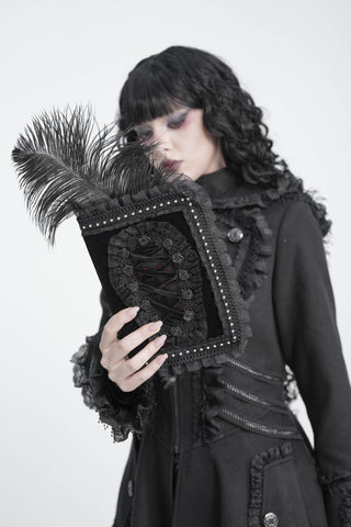 Model holding the Devil Fashion AS320 black velvet A5 notebook cover with corset-style lacing, rose trim and ruffled edges.