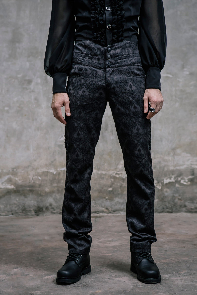 Front view of men’s Gothic brocade pants with damask pattern and lace-up side detail, worn with black ruffled shirt and boots.
