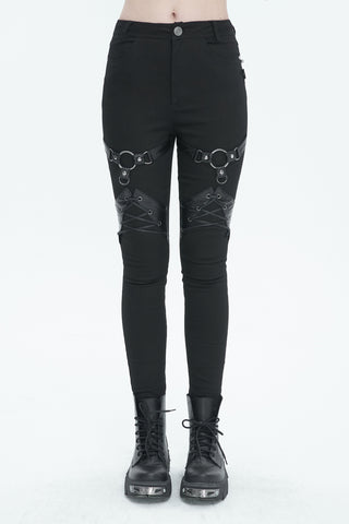 Front view of Devil Fashion PT214 black skinny pants with faux leather harness straps and metal O-ring accents, styled with combat boots on white background